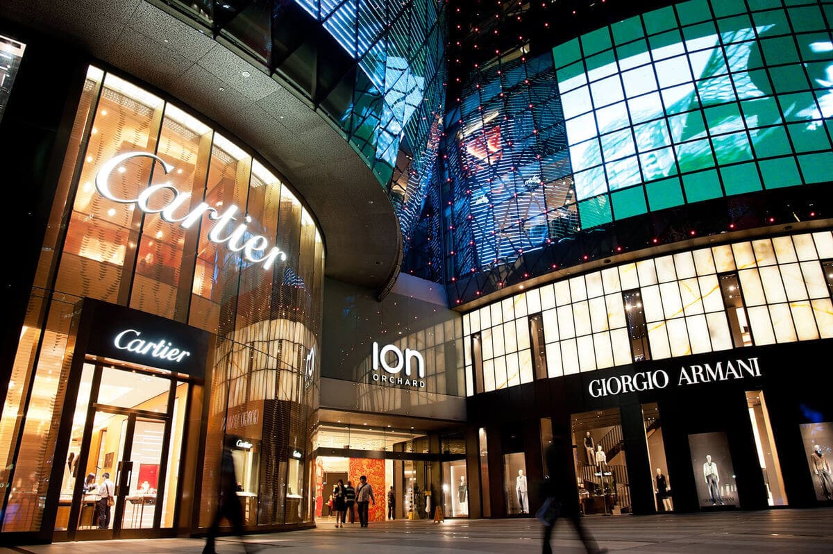 the interior of a large retail shopping center with cartier and armani stores